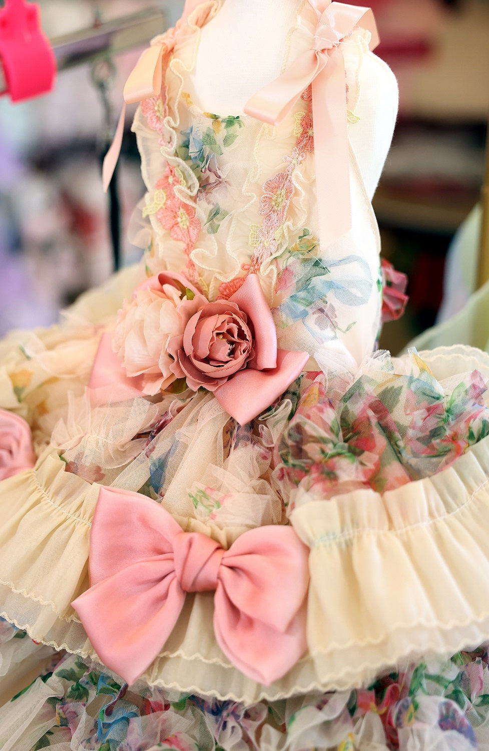 Floral and bow decorative item with a soft color palette.