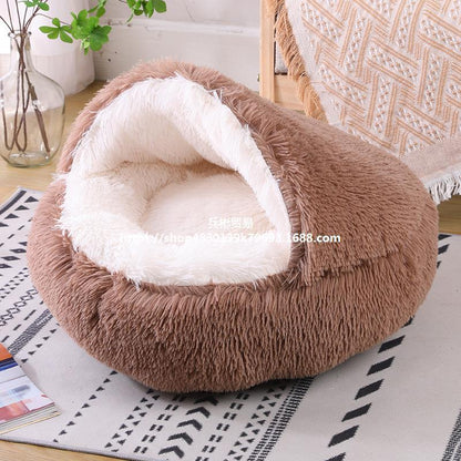 Brown pet bed with white interior on a patterned surface