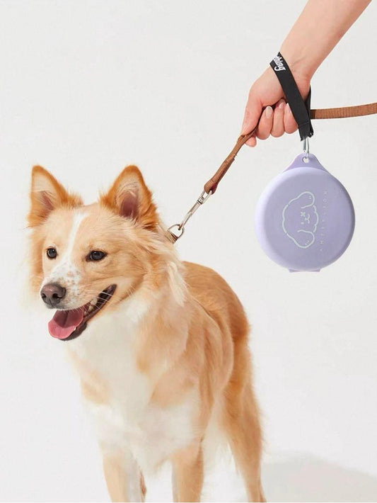 Dog on a leash with a purple device held by a person against a white background