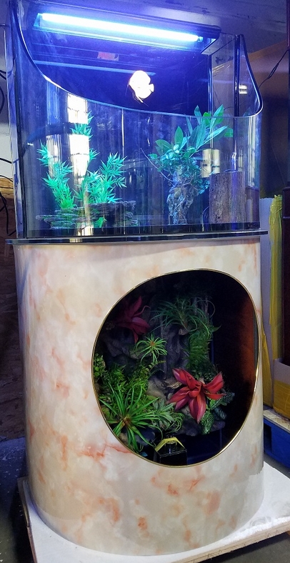 Decorative fish tank with plants and a light fixture inside