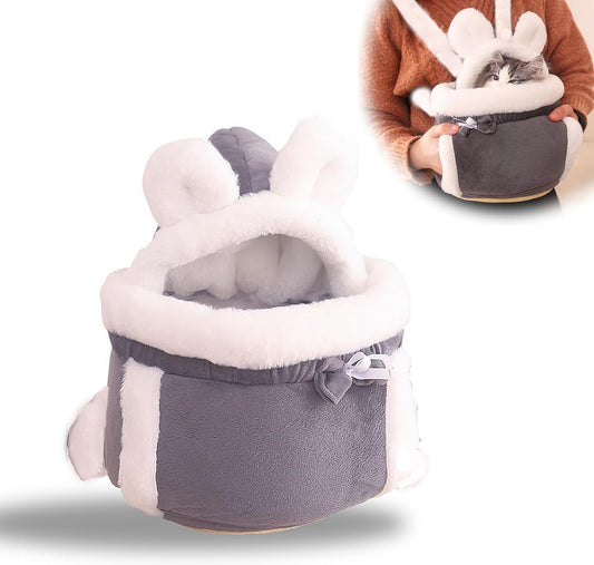 Pet carrier with bunny ears held by a person on a white background