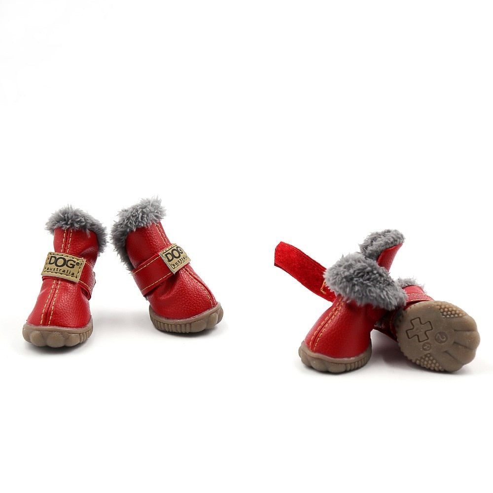 Red pet boots with gray fur trim on a white background