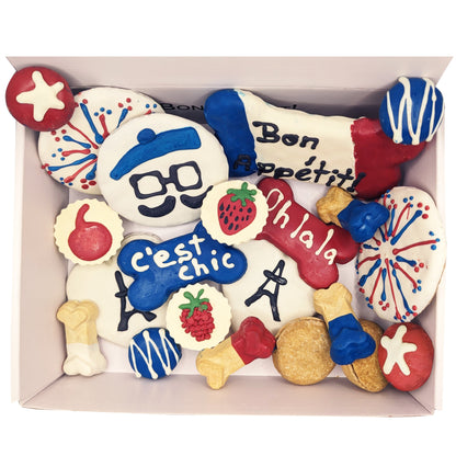 Assorted cookies with colorful designs and text in a box