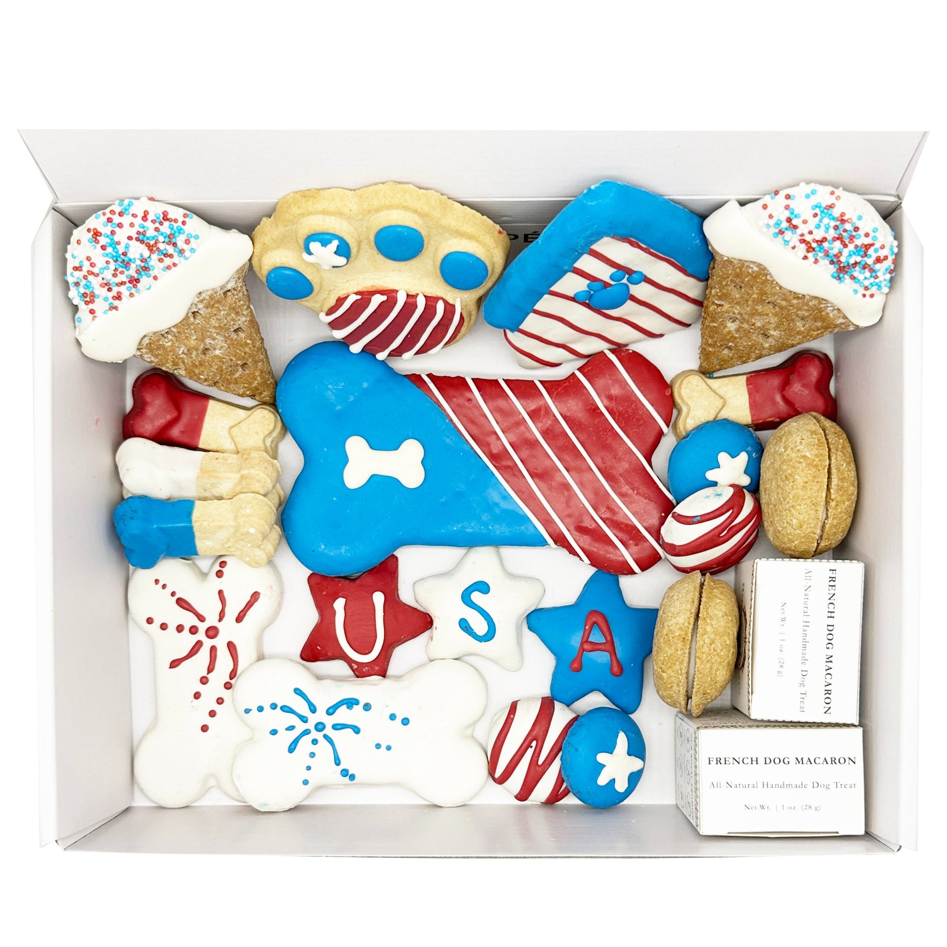 Assorted dog treats in a box with patriotic designs