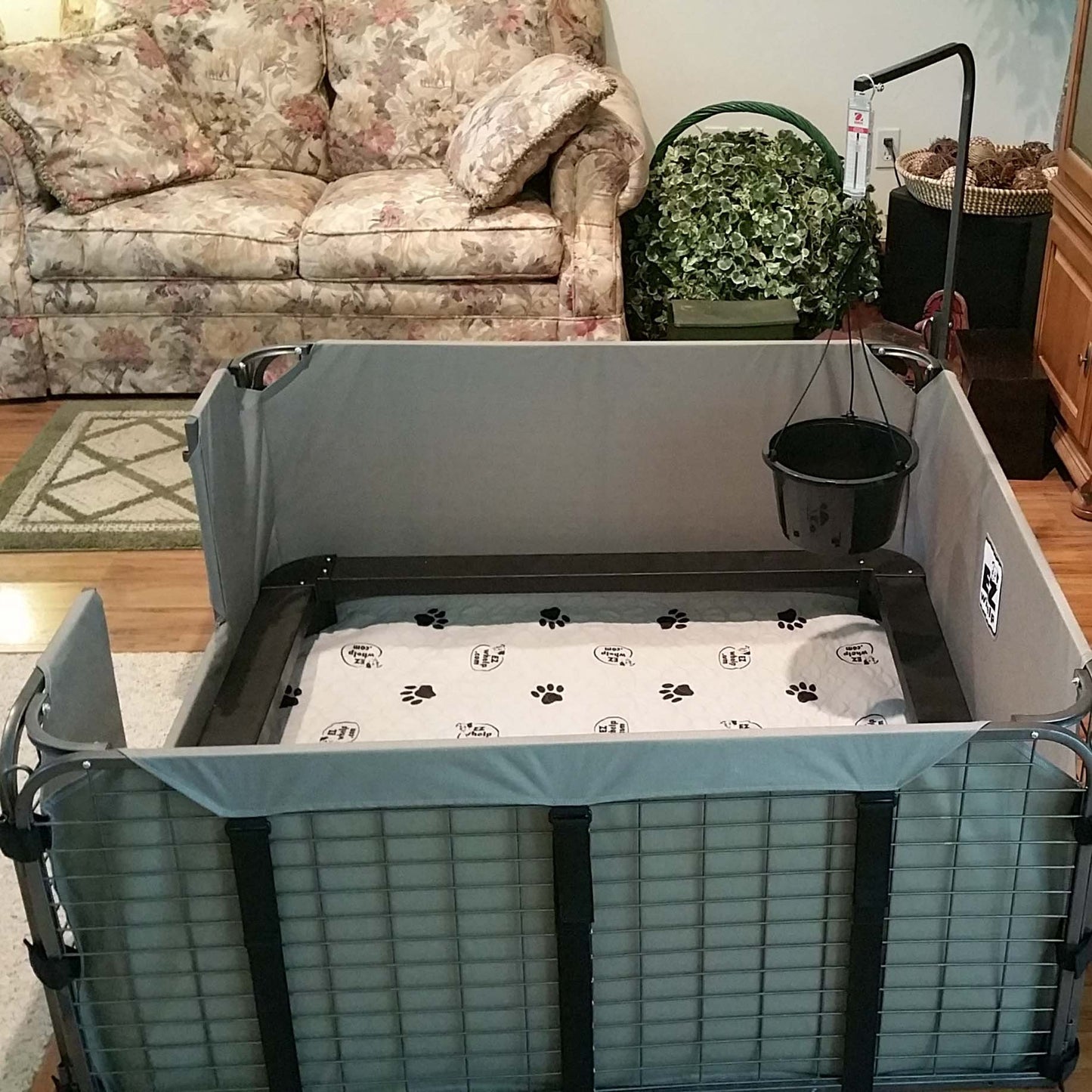 Pet playpen with a mat inside in a living room setting