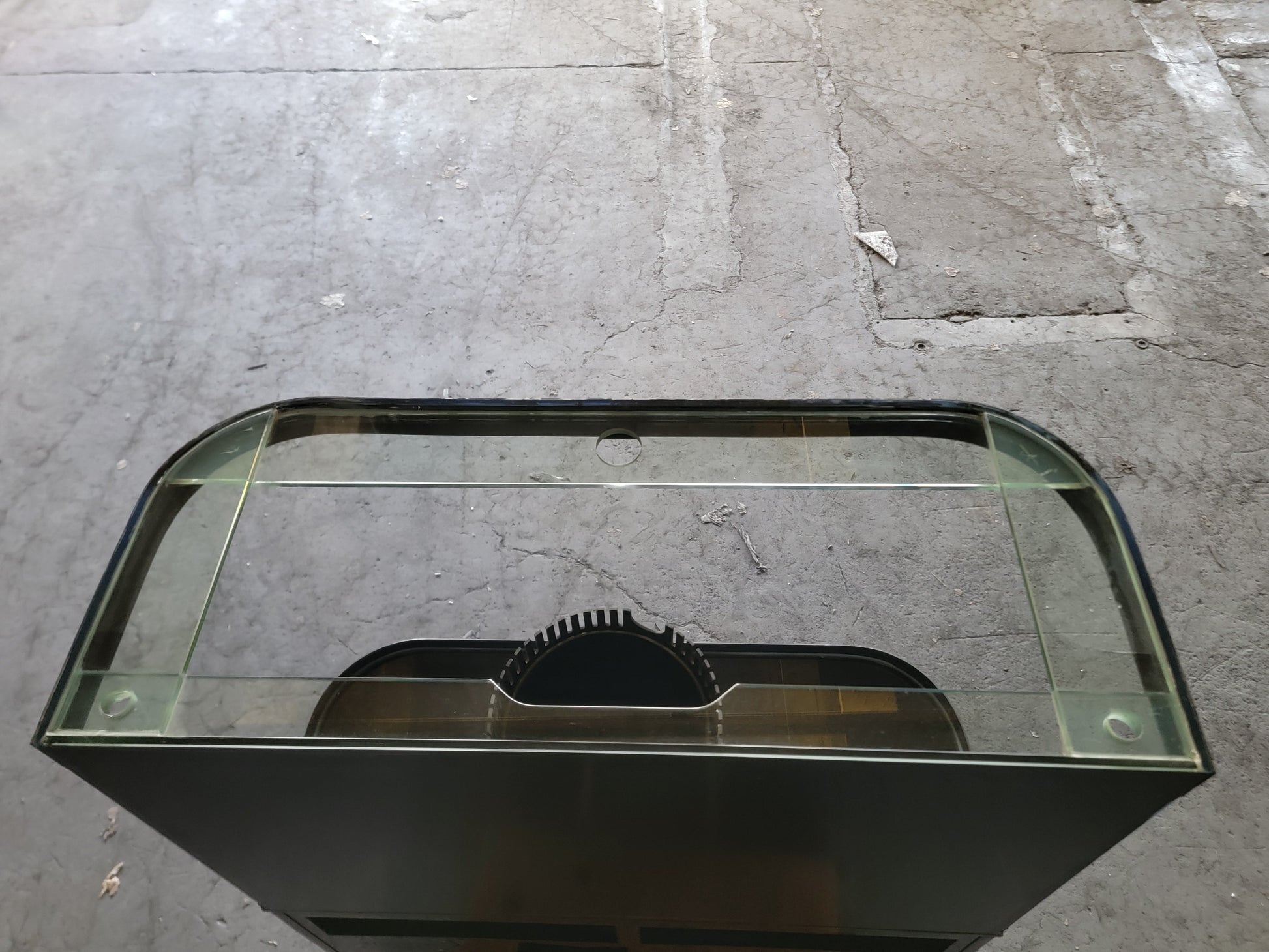 Black metal and glass display case on a concrete floor