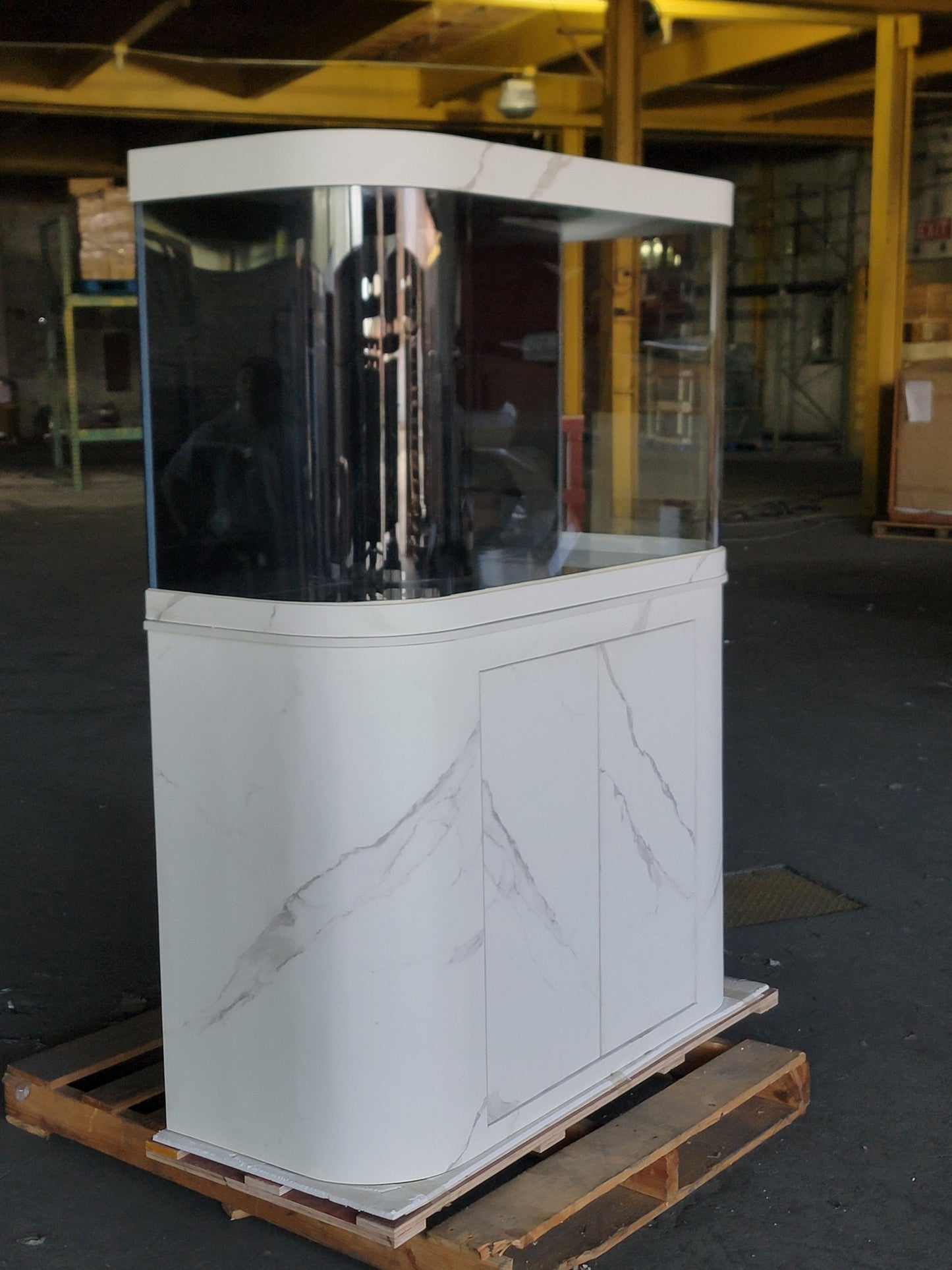 White display case with marble pattern on a pallet in an industrial setting