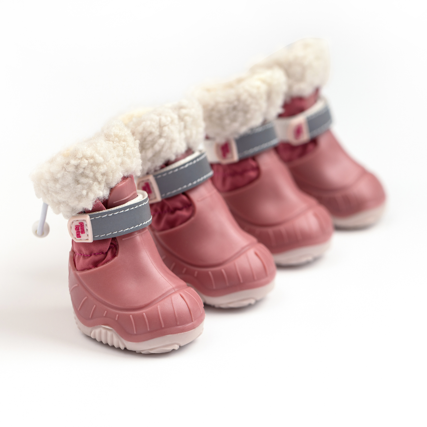 Set of pink dog boots with white fur lining on a white background