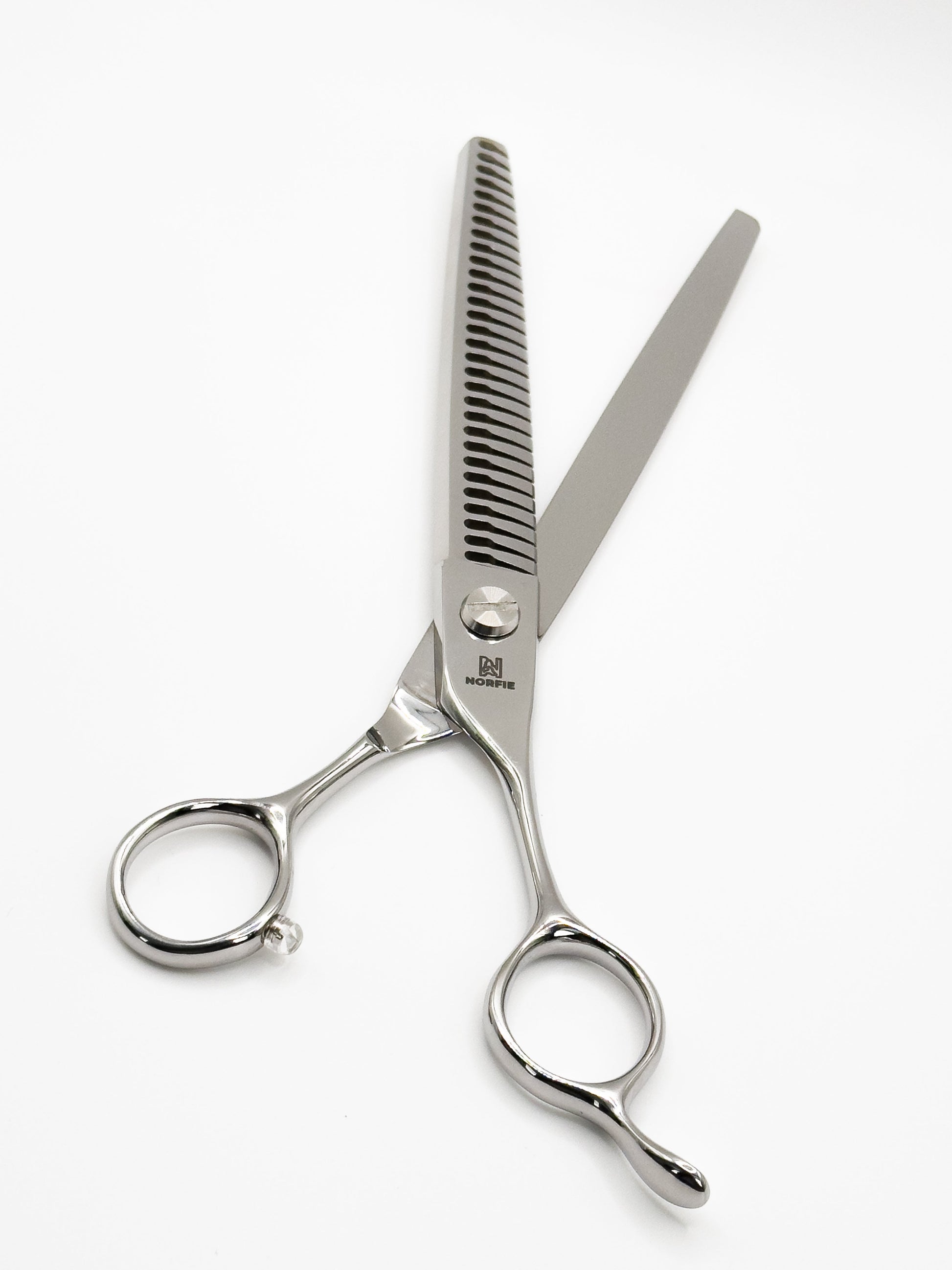 Hair cutting shears with a comb on a white background