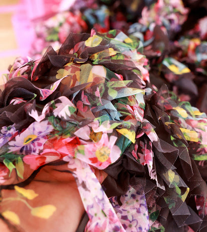 Colorful fabric headband with floral patterns on a blurred background