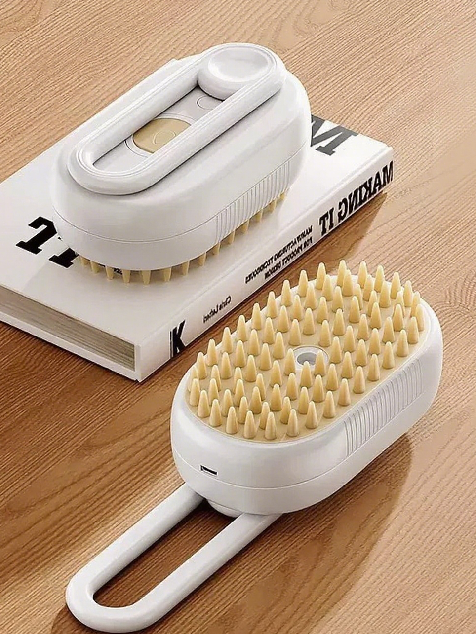 Two white cleaning brushes with bristle heads on a wooden surface.