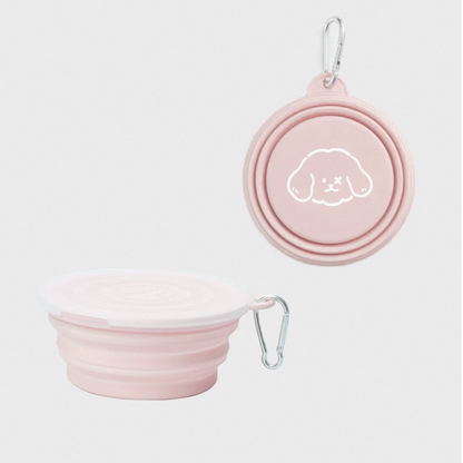 Pink collapsible dog bowl with lid and carabiner on a white background