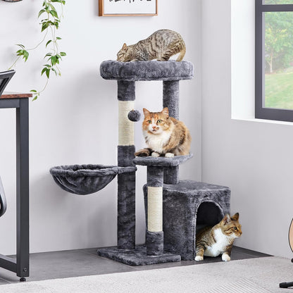 Cat tree with cats on a gray carpeted floor