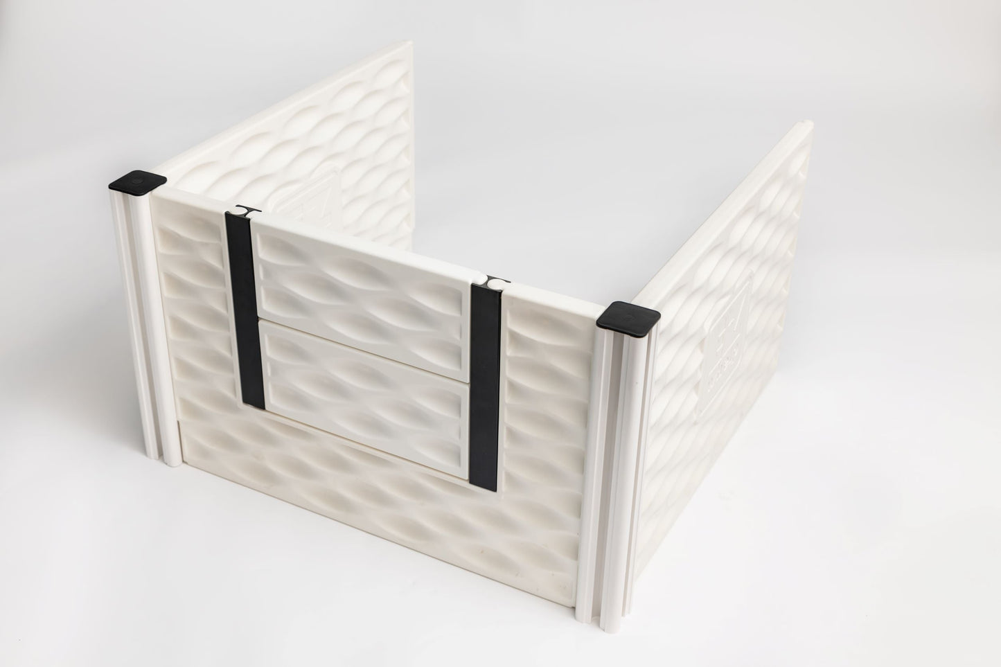 White pet gate with black straps on a light gray background