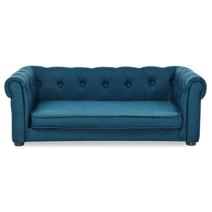 Blue tufted sofa on a white background