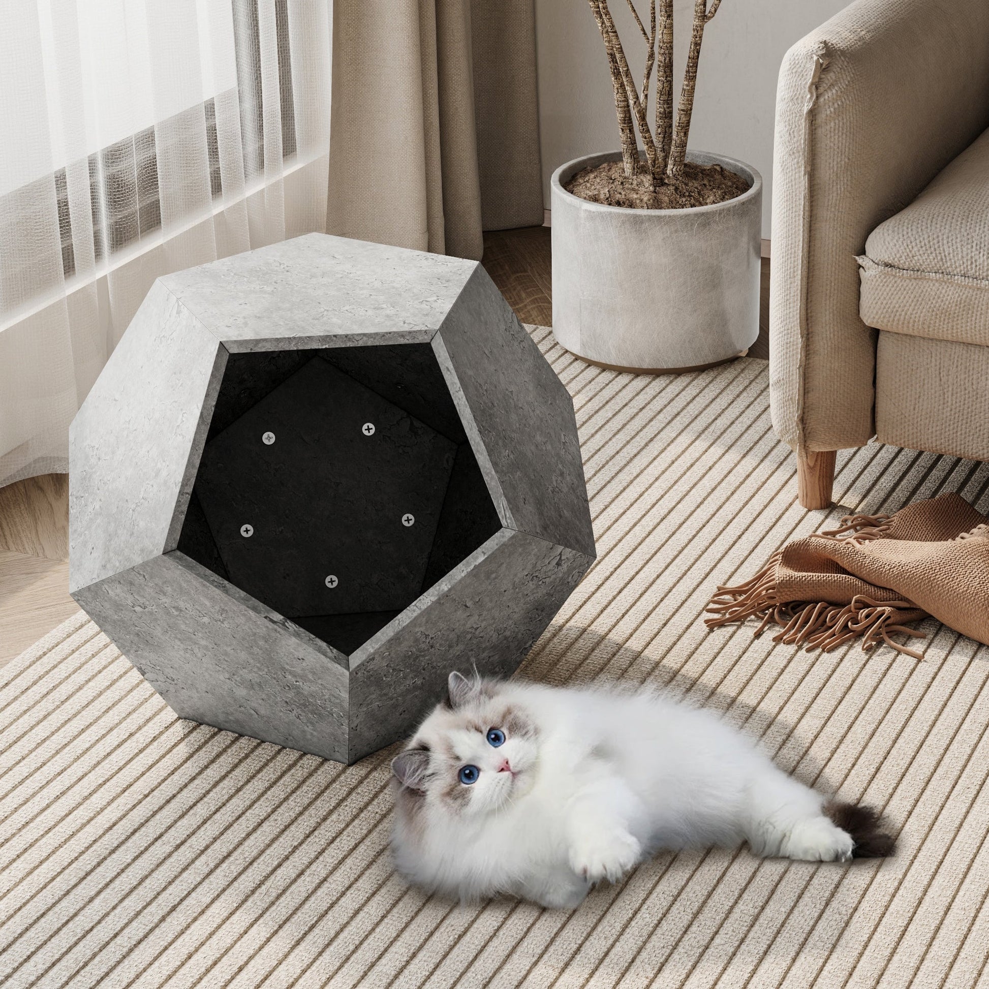 Geometric pet bed with a cat lying on a carpeted floor in a living room.