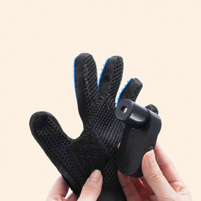 Black grooming glove with blue accents held by a hand on a beige background