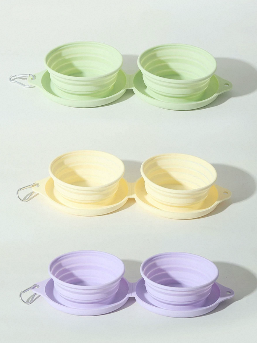 Set of collapsible bowls and saucers in green, yellow, and purple on a white background