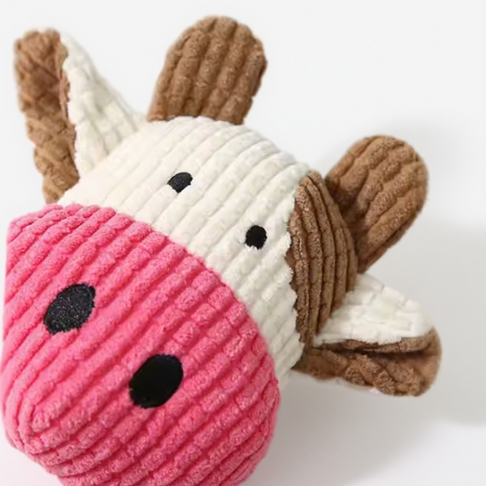 Plush toy resembling a deer with a pink snout on a white background