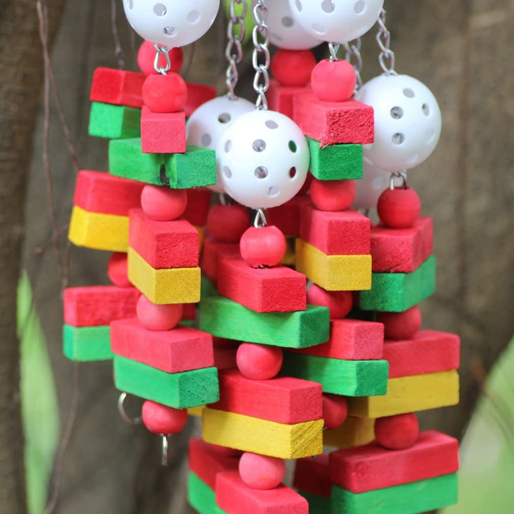 Colorful bird toy made of stacked wooden blocks and plastic balls on a blurred background