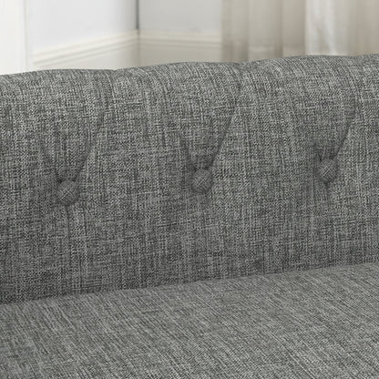 Gray fabric sofa with tufted button details in a room setting.