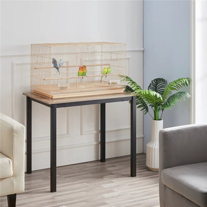 Birdcage on a table in a room with a plant and furniture