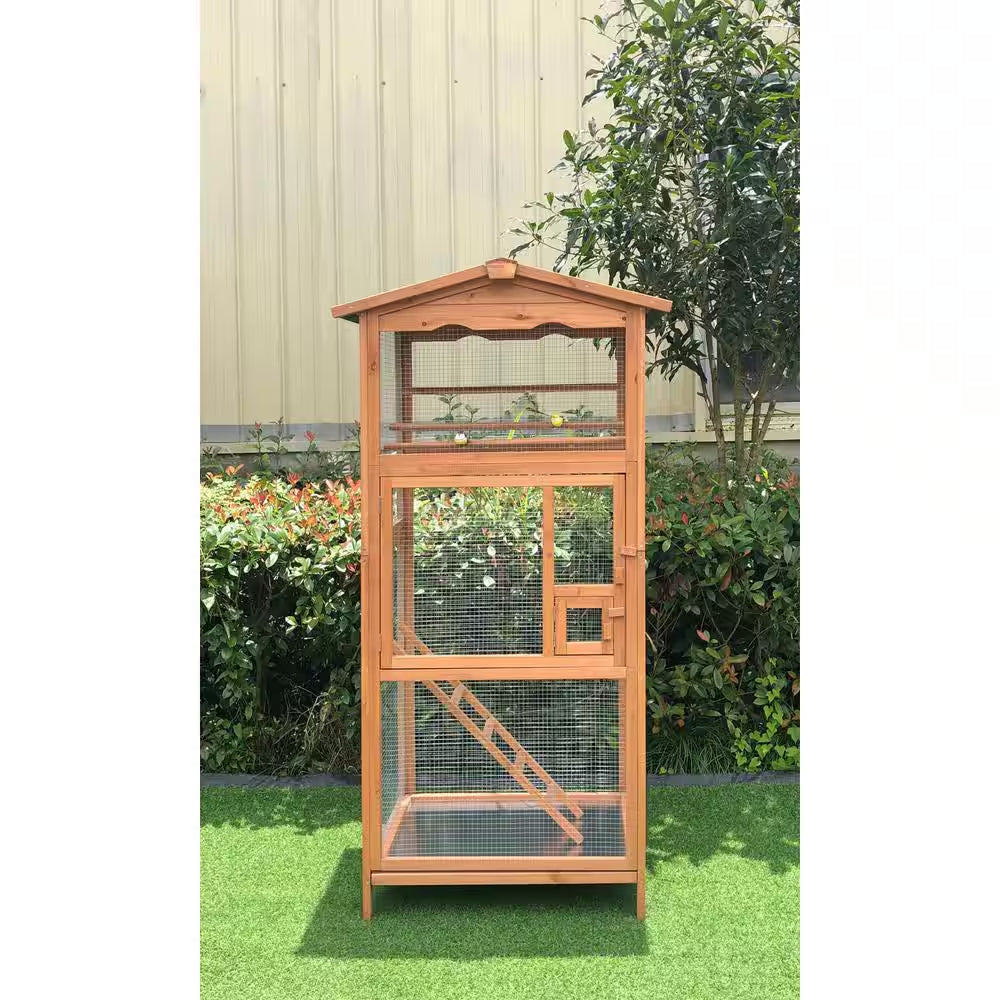 Wooden bird cage with a roof in an outdoor setting