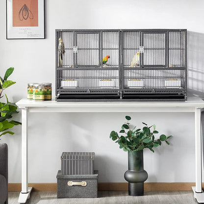 Two bird cages on a white table with birds inside, surrounded by plants and decor.
