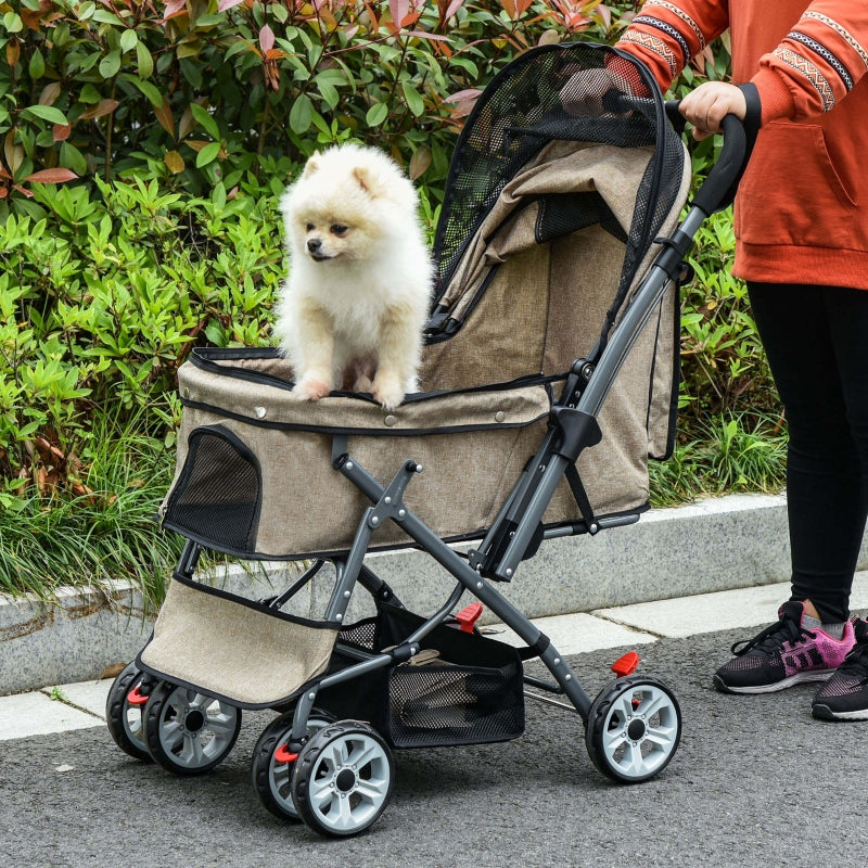 Person pushing a pet stroller with a small white dog inside, outdoors.
