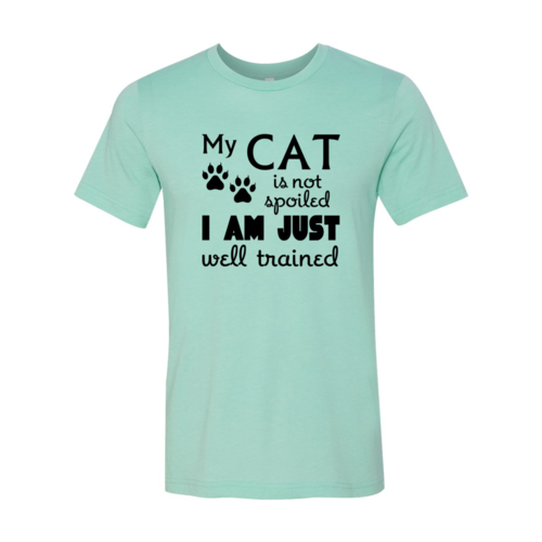 Mint green t-shirt with black text and paw prints on a white background