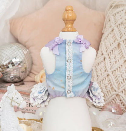 Mannequin wearing a pastel-colored outfit with decorative elements on a soft, textured background.
