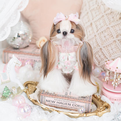 Small dog with decorative hair bow on a decorative stand with pastel colors