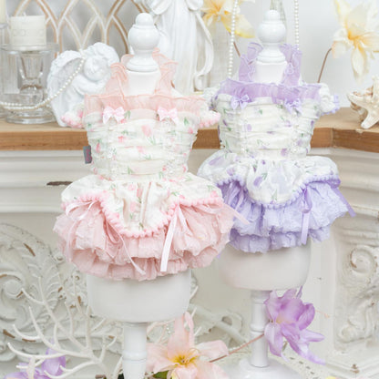 Pastel-colored ruffled petticoats on mannequins with a decorative background.