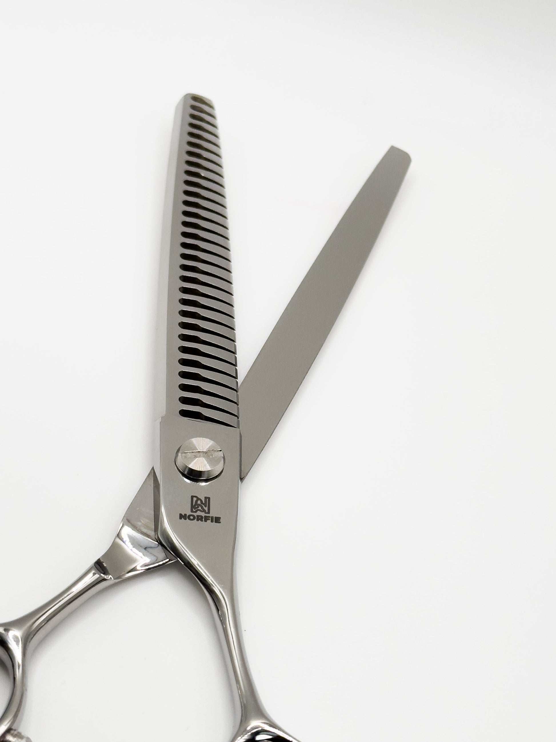 Hair cutting scissors with a comb on a white background