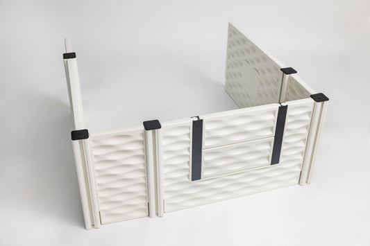 White pet gate with black accents on a white background