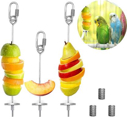 Fruit skewer with sliced apples, oranges, and pears, hanging from a hook, with additional skewers and attachments on a white background.