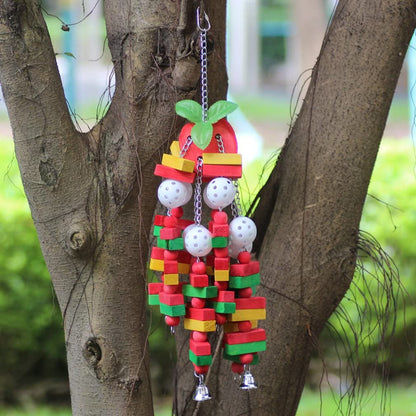 Colorful bird toy hanging from a tree branch with a natural background