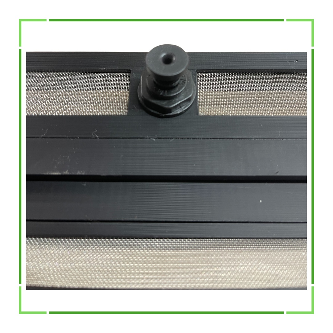 Close-up of a black screen door with a mesh pattern and a central pivot point.