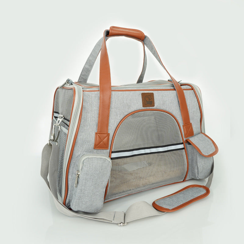 Gray pet carrier with brown handles and trim on a white background