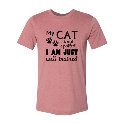 Pink t-shirt with black text and paw prints on a white background