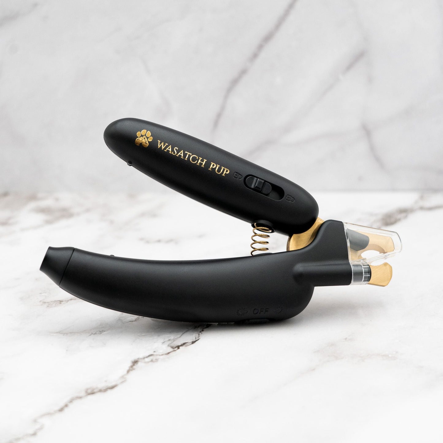 Black electronic device with 'Wasatch Pup' branding on a marble surface