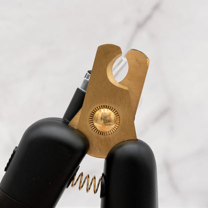 Black and gold tool with a spring mechanism on a white background