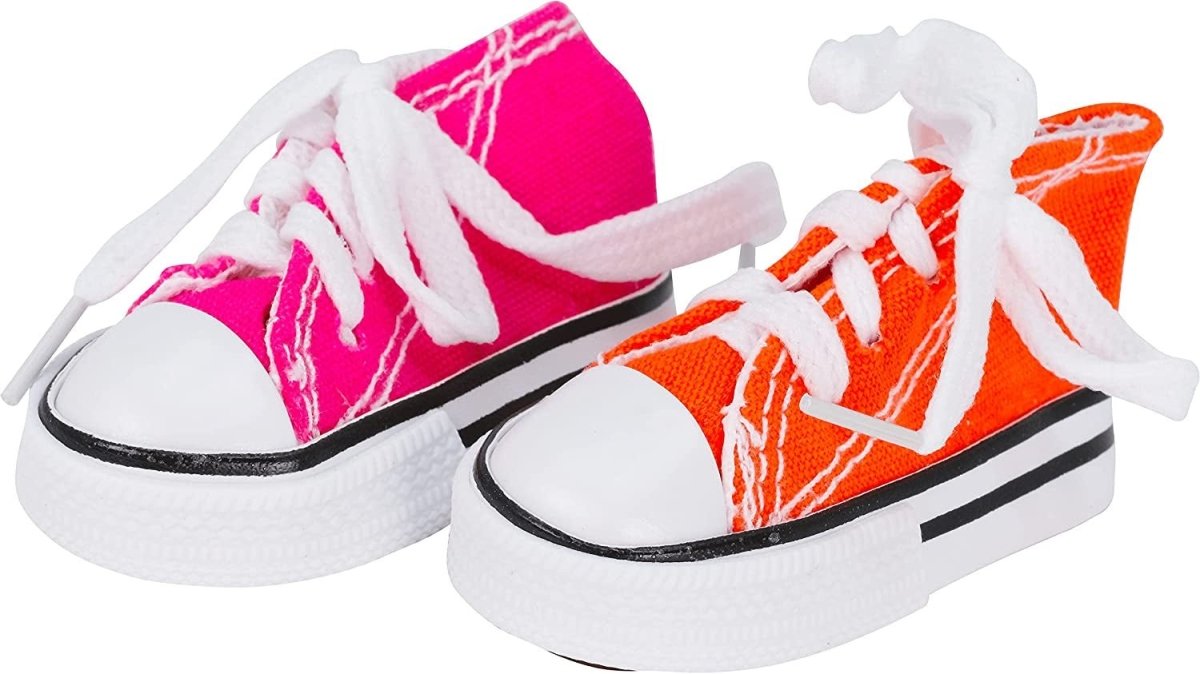 Pair of pink and orange sneakers with white laces on a white background