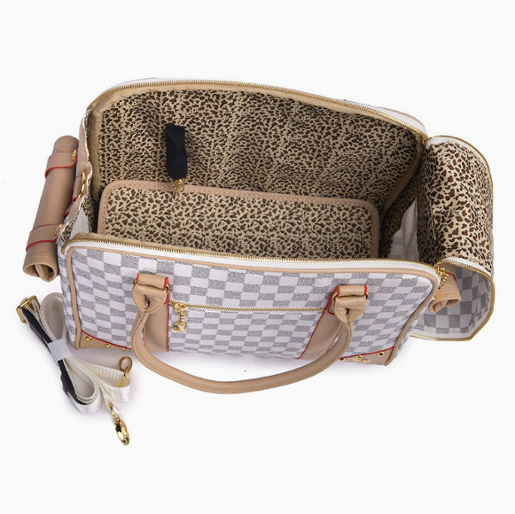 Designer handbag with leopard print interior on a white background