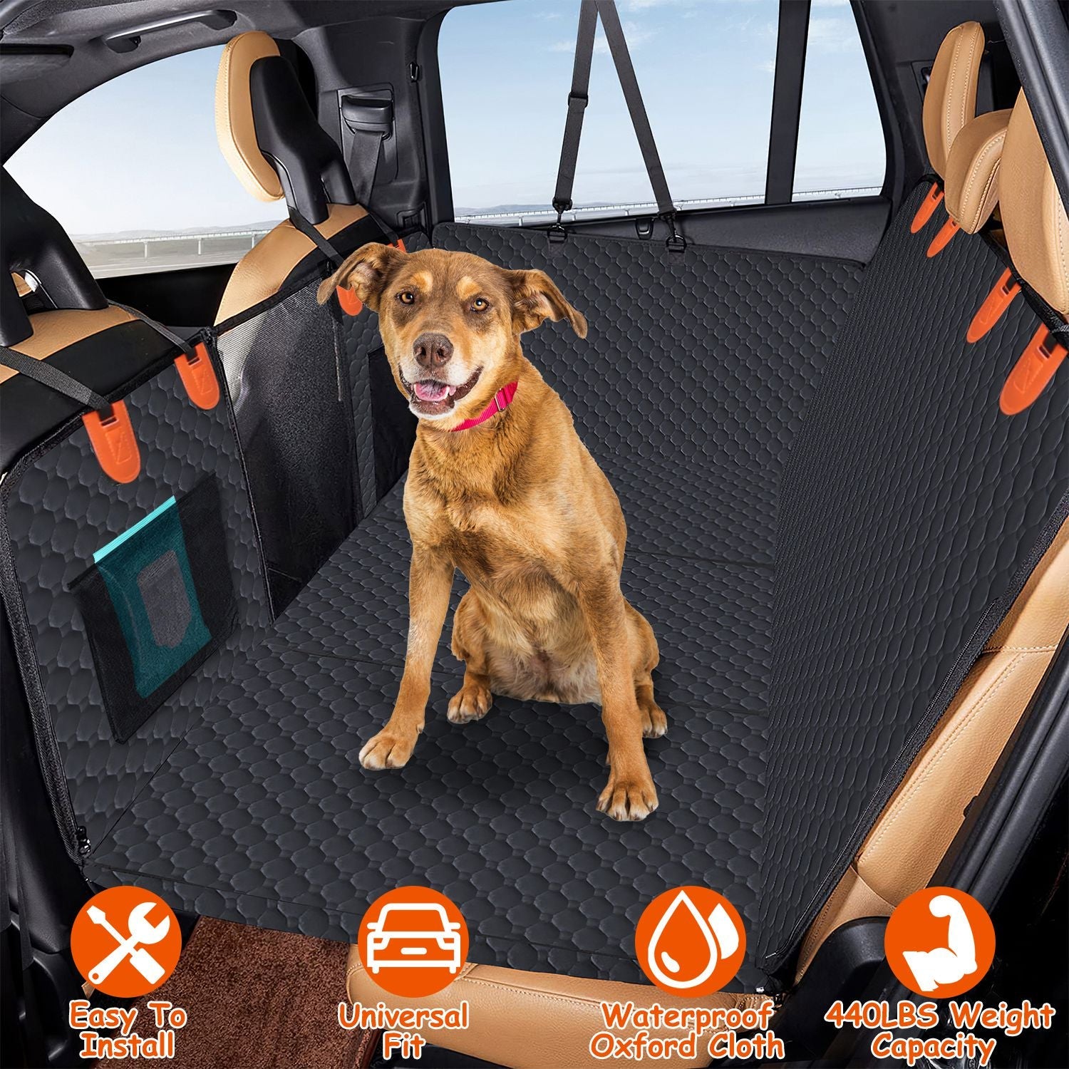Dog sitting on a black car seat cover with orange accents in a vehicle.