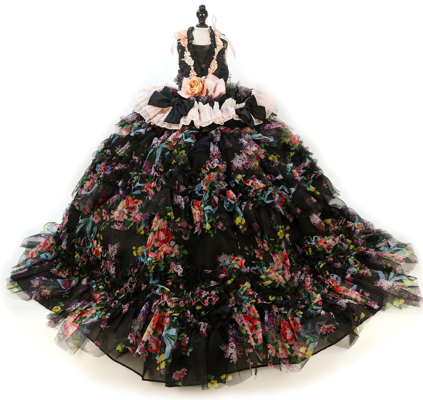 Black floral gown on a mannequin against a white background