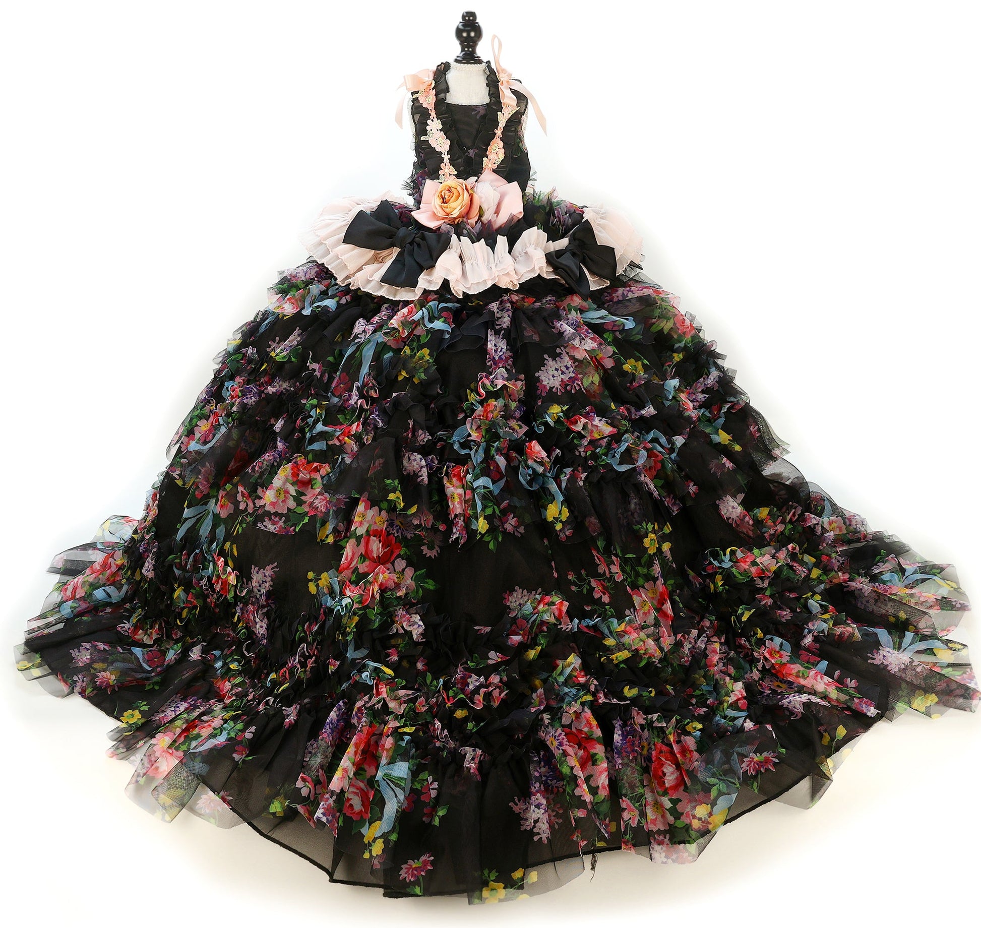 Black floral gown on a mannequin against a white background