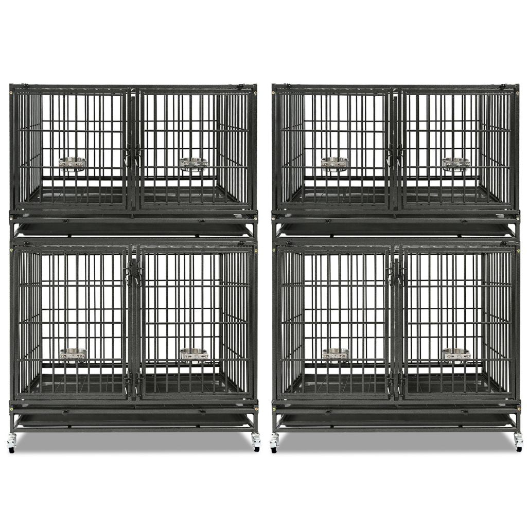 Four black metal dog crates stacked on a white background