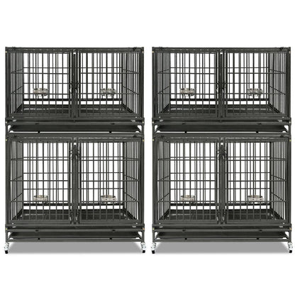 Four black metal dog crates stacked on a white background