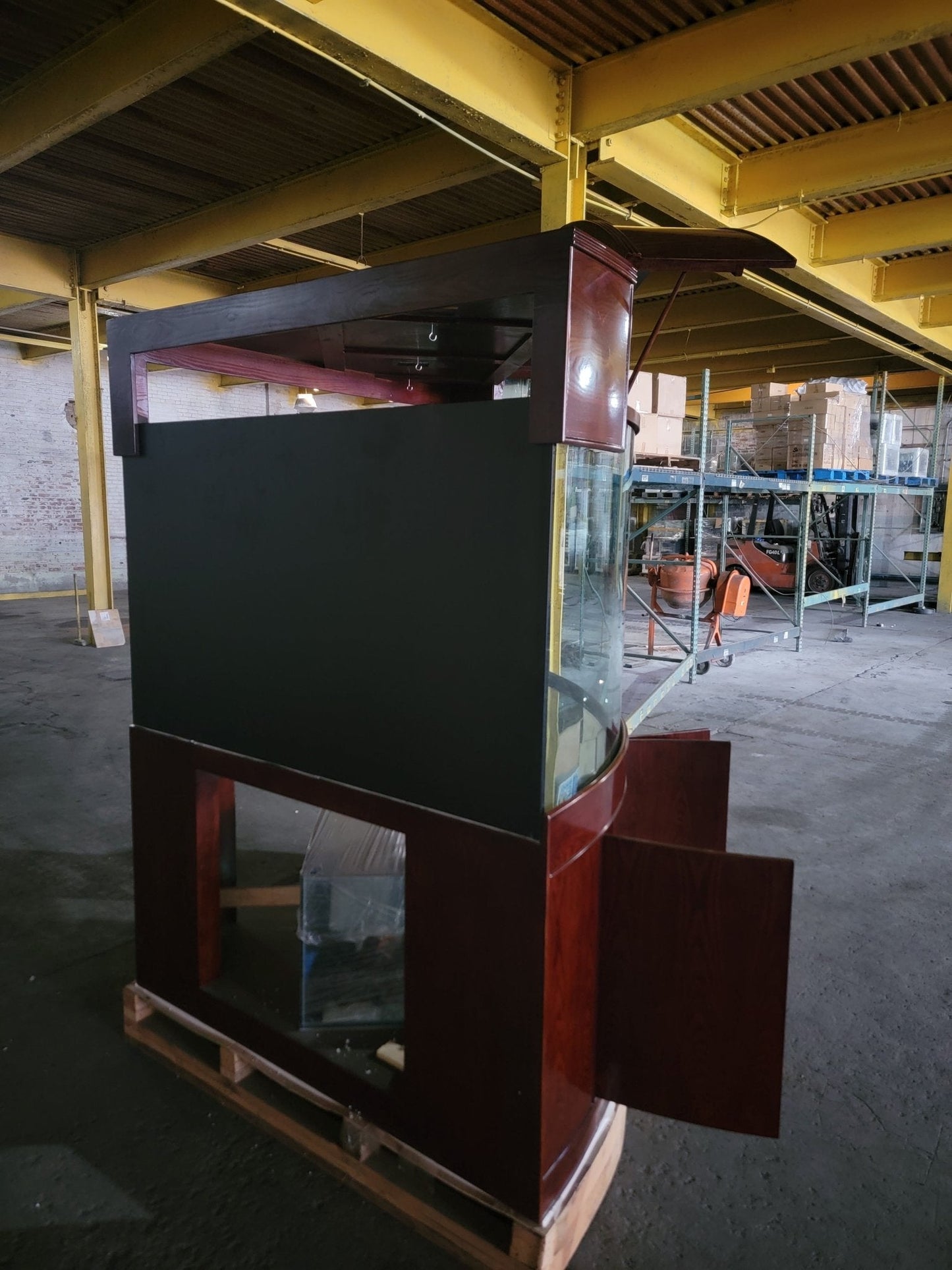 Large fish tank on a pallet in an industrial setting